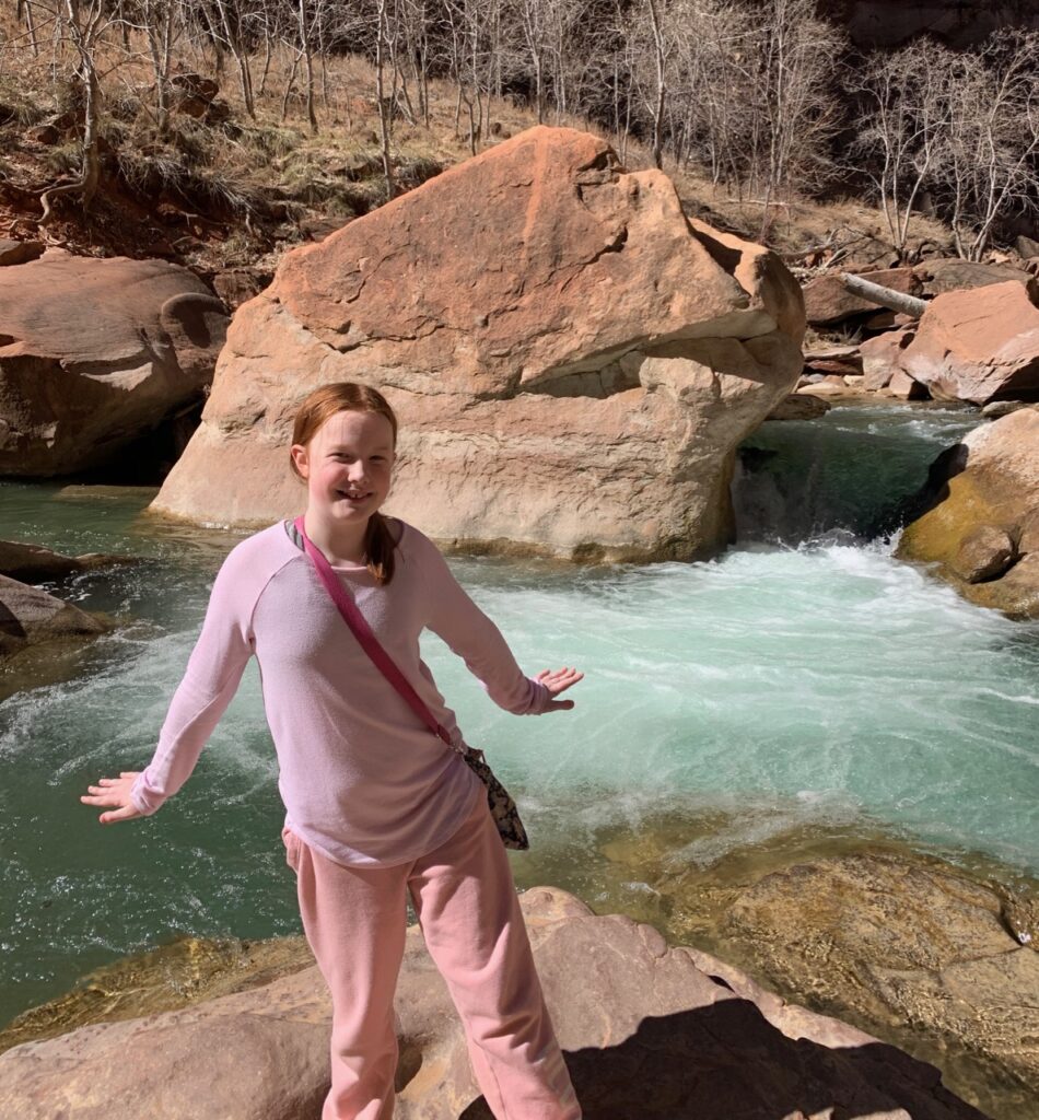 Cameron hiking to the end of the Narrow Trail in Zion National Park, with the river rushing away in the background. 