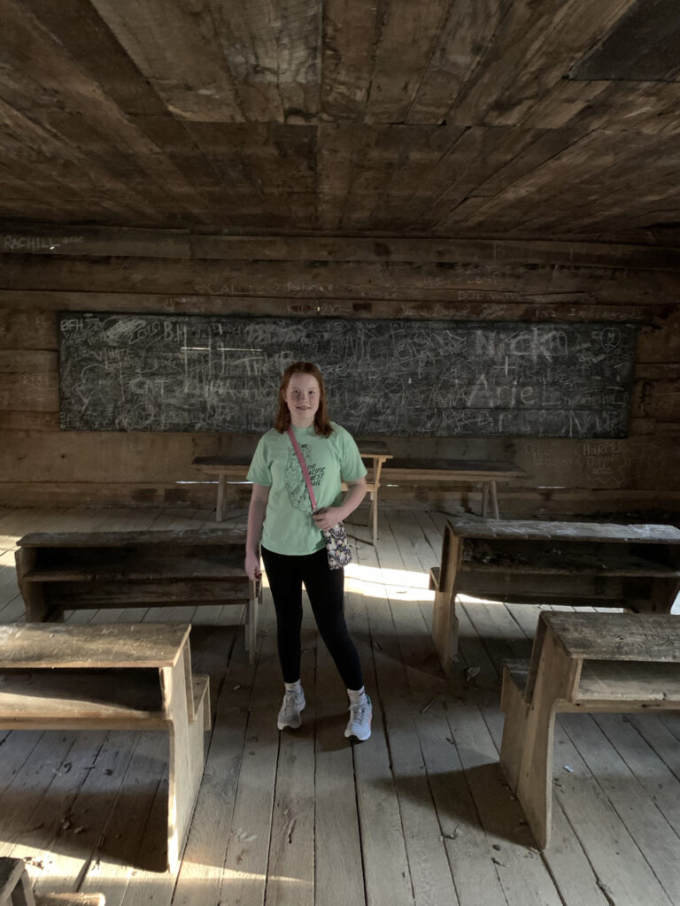 Cameron standing in side the historic Little Greenbrier School house in the Great Smoky Mountains.