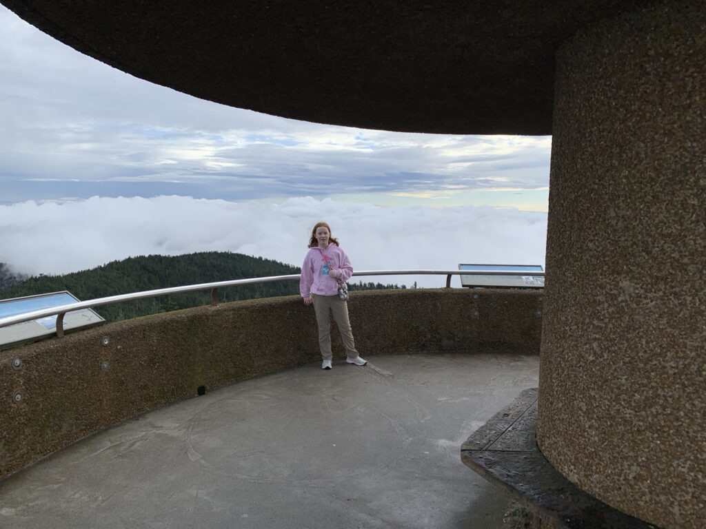 Cameron standing on top of Clingmans Dome, low clouds cover the valley behind us.