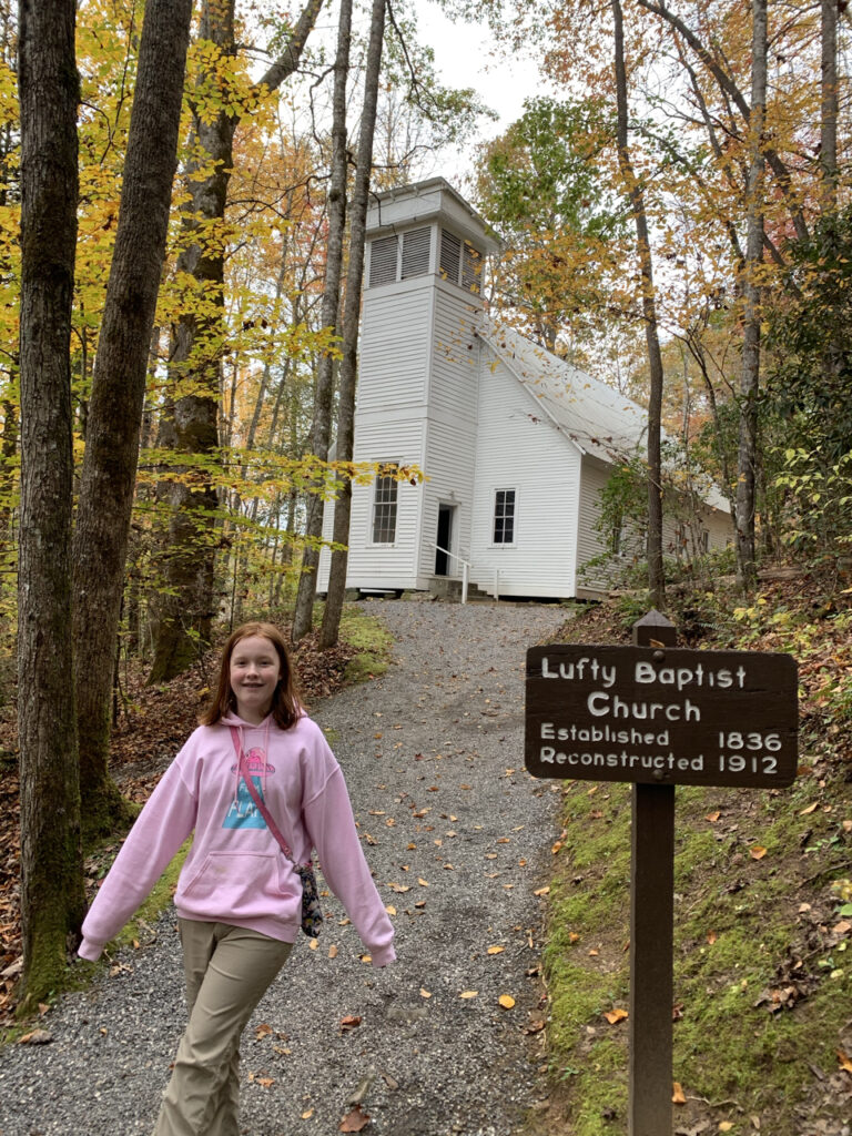 Cameron walking back from the Lufty Baptist Church in the Great Smoky Mountains National Park. The tree lined path is full of fall colors. 