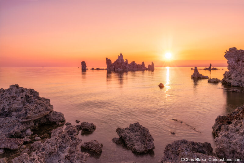 A stunning sunrise over Mono Lake in California, showcasing the unique tufa towers. These limestone formations, previously submerged, now stand tall against the horizon due to lower water levels. The image combines various shots taken over several hours to capture the serene beauty and ethereal quality of this iconic landscape. Ideal for nature and photography enthusiasts, this scene evokes the feeling of a hike during sunrise at Mono Lake, highlighting the park's geological marvels and tranquil atmosphere.