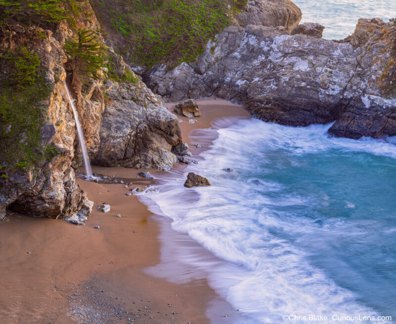 McWay Falls is an 80-foot waterfall in Julia Pfeiffer Burns State Park, plunging from a high granite cliff into the ocean at Monterey Bay. This image captures the falls at sunset with a panoramic view, composed of nearly 10 photos. The trail to the usual viewing spot has collapsed, but the vantage point provides a stunning perspective on the cascading waterfall, the textured cliff face, and the tranquil ocean. This high-resolution 300-megapixel image showcases the vibrant colors and intricate details of the scene.