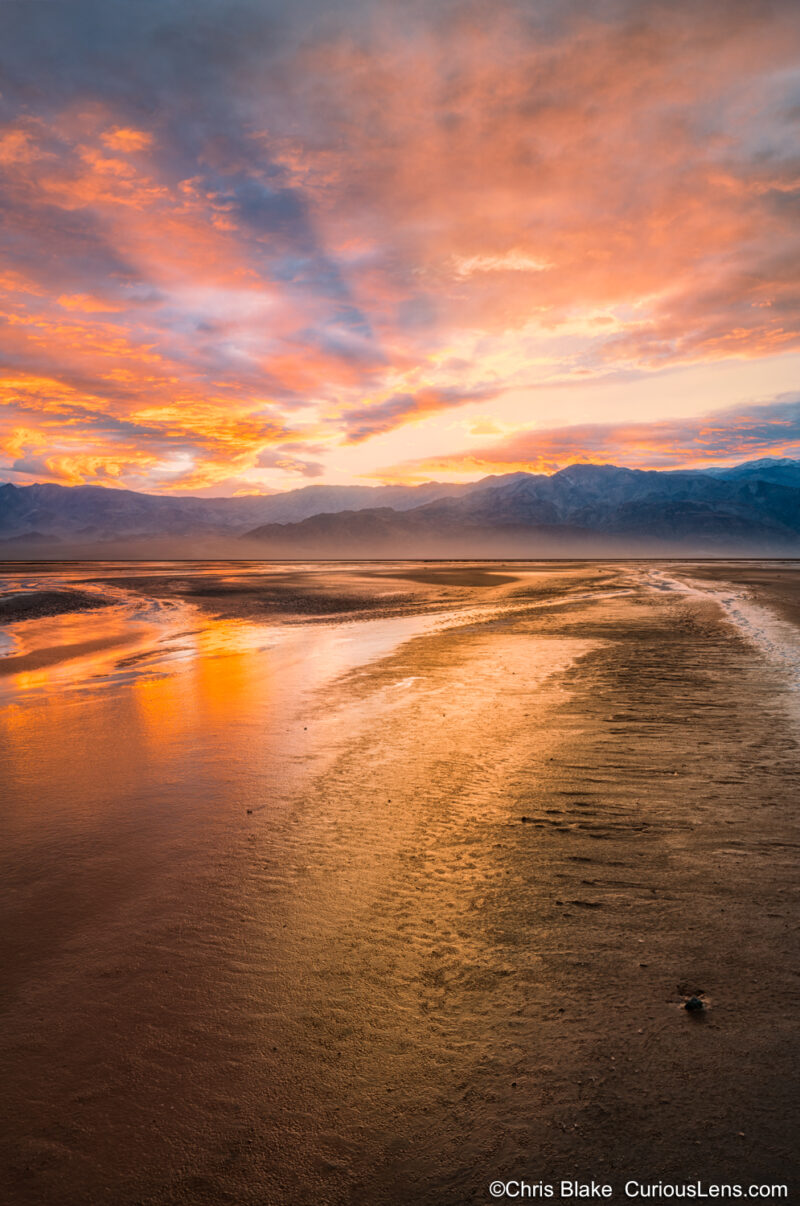 Sunset in a very unusually wet Death Valley nation Park. The ground was pooled with water, and the sky was an amazing red and yellow.