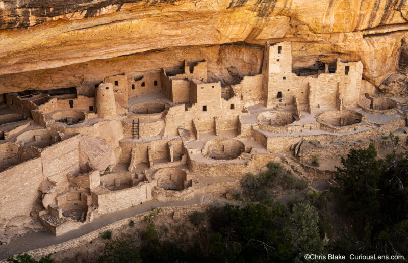 Cliff Palace at Mesa Verde National Park in Colorado, the largest cliff dwelling in North America, built by Ancestral Puebloans around 1190 AD. Photographed with soft, reflected light to reduce harsh shadows and reveal intricate details, capturing the impressive scale and historical significance of the ancient structures. The photo was taken from a viewpoint on the rim, highlighting the grandeur of this archaeological site.