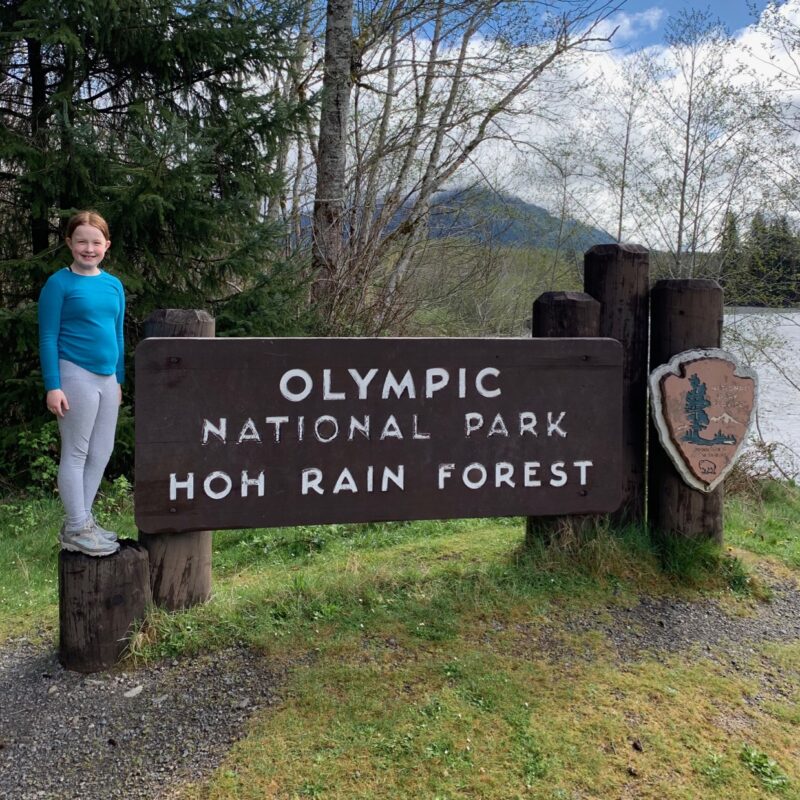 Cameron posing for a photo on the Olympic National Park sign.