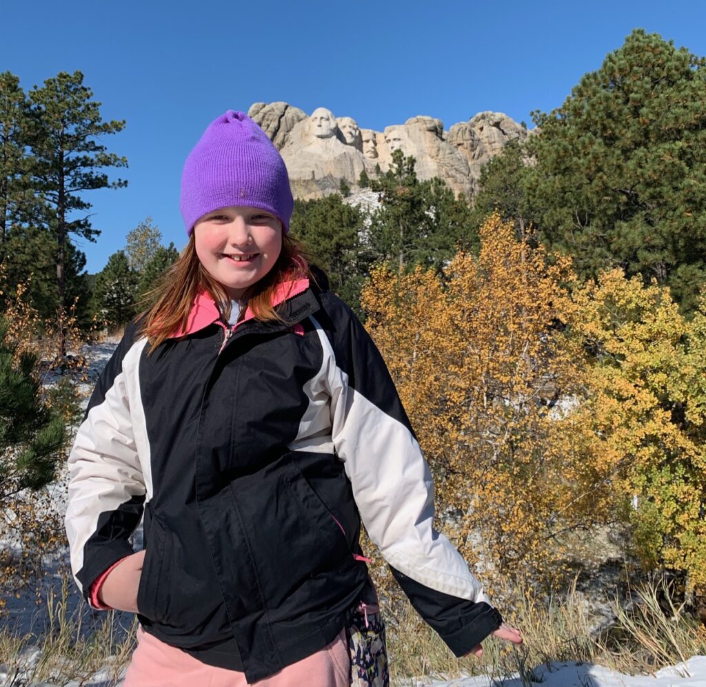 Cameron posing for a photo at Mount Rushmore.