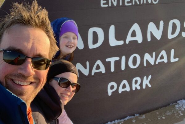 Cameron, Cat and myself in front of the park singe for Badlands National Park.