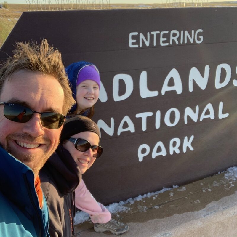 Cameron, Cat and myself in front of the park singe for Badlands National Park.