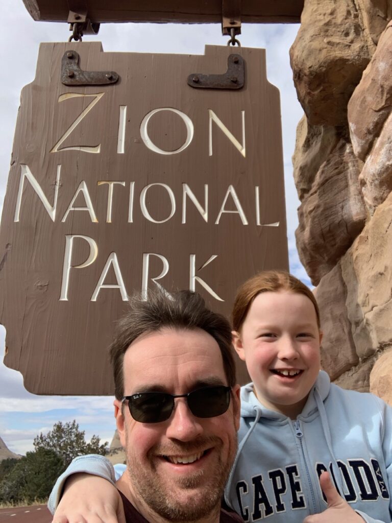 Cameron and myself in front of the park sign to Zion National Park, Utah.