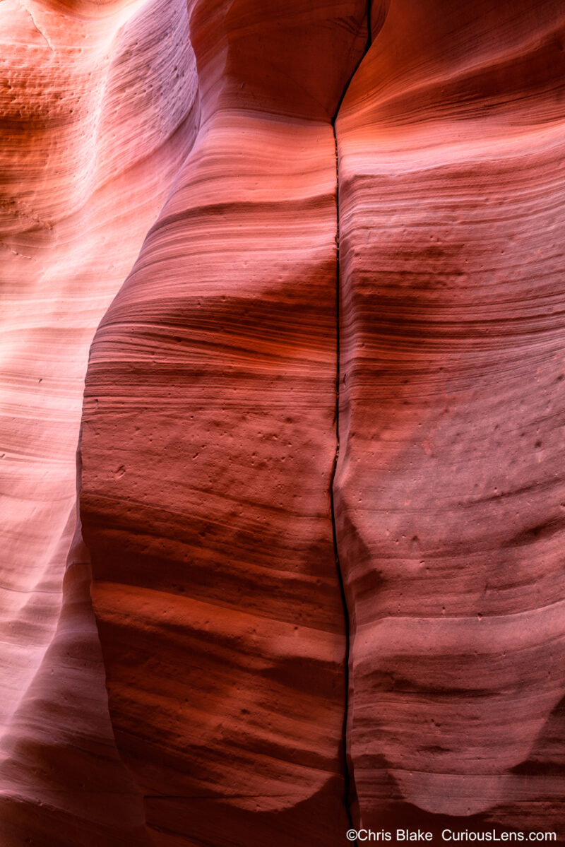 Antelope Canyon, located near Page, Arizona, is a famous series of slot canyons formed by water and wind erosion over millions of years. This process has sculpted the soft sandstone into smooth, flowing shapes, creating a unique and captivating landscape. In this photo, I'm not following the typical upward perspective; instead, I'm focusing on a close-up view of the canyon wall. The image captures intricate shapes, sweeping lines, vibrant colors, and dramatic shadows, offering a fresh and intriguing composition that draws the viewer in. The longer you examine the image, the more details emerge, highlighting the beauty and wonder of this natural formation.