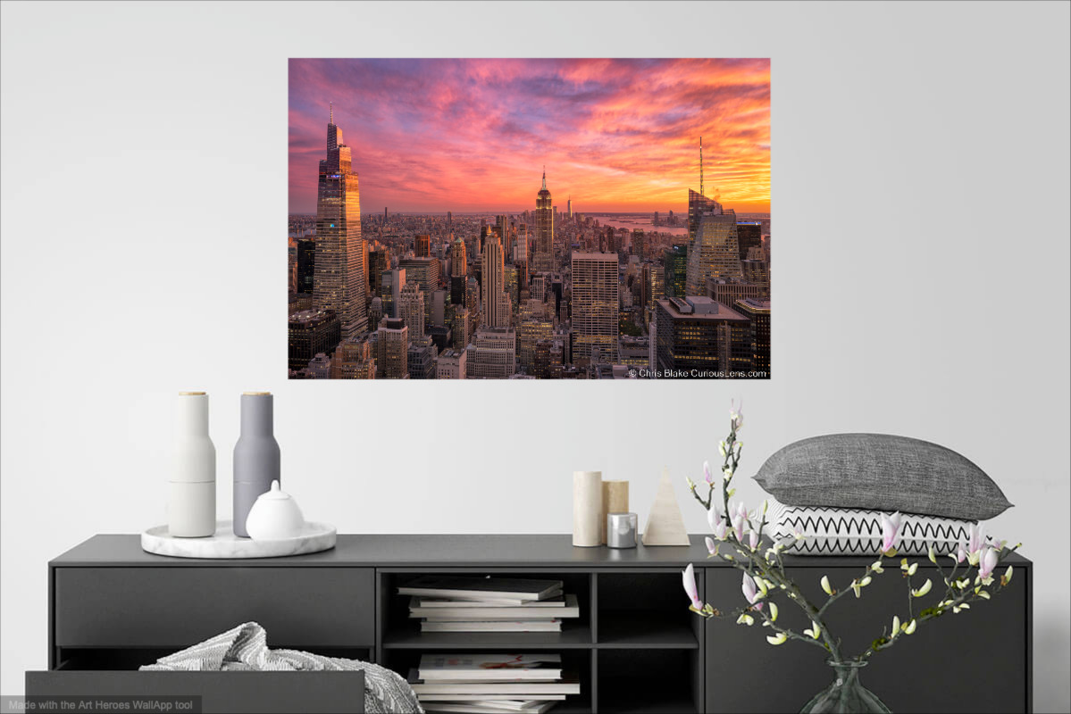 Photo print, hung in a dinning room. Photo is New York City at sunset taken from the top of the rock with a bright red sky.