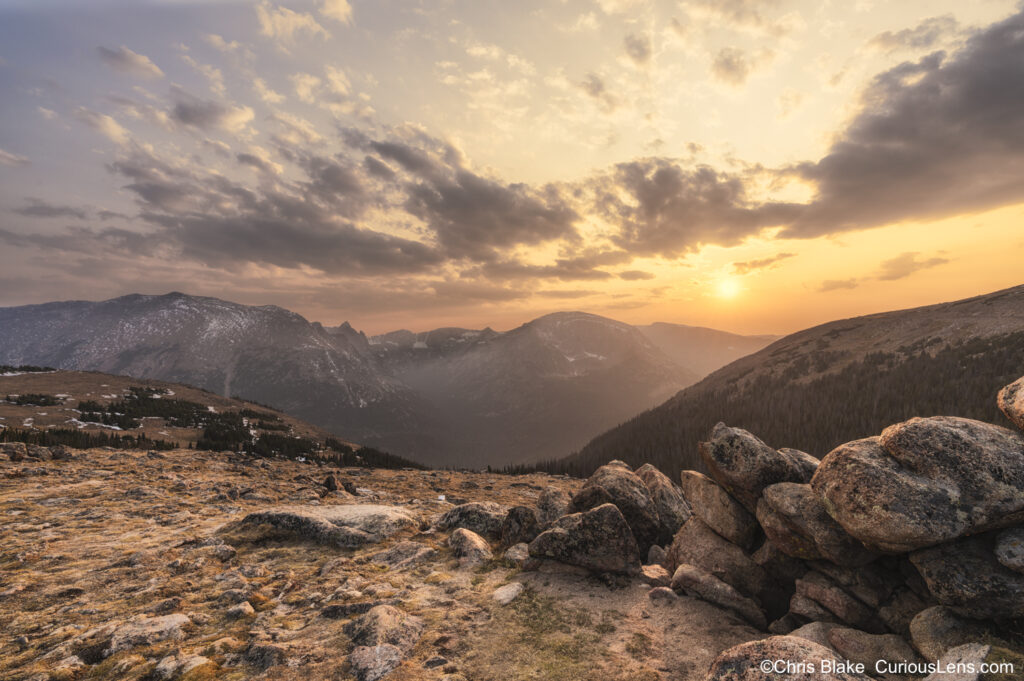 Sunset on Ute Trail in Rocky Mountain National Park with alpine tundra, smoky haze, vibrant sky, and wildlife including marmots.