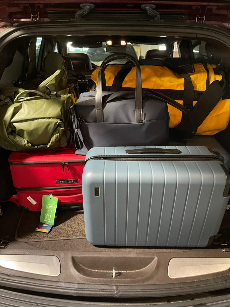 The back of our SUV packed to the roof with suitcases and duffel bags.