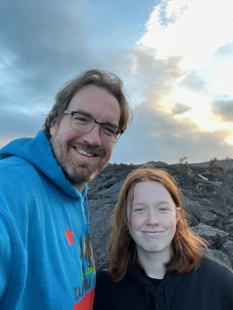 Cameron and myself at sunset on the Devastation Trail in Volcanos National Park. Standing on the lava field with an amazing sky behind us. 