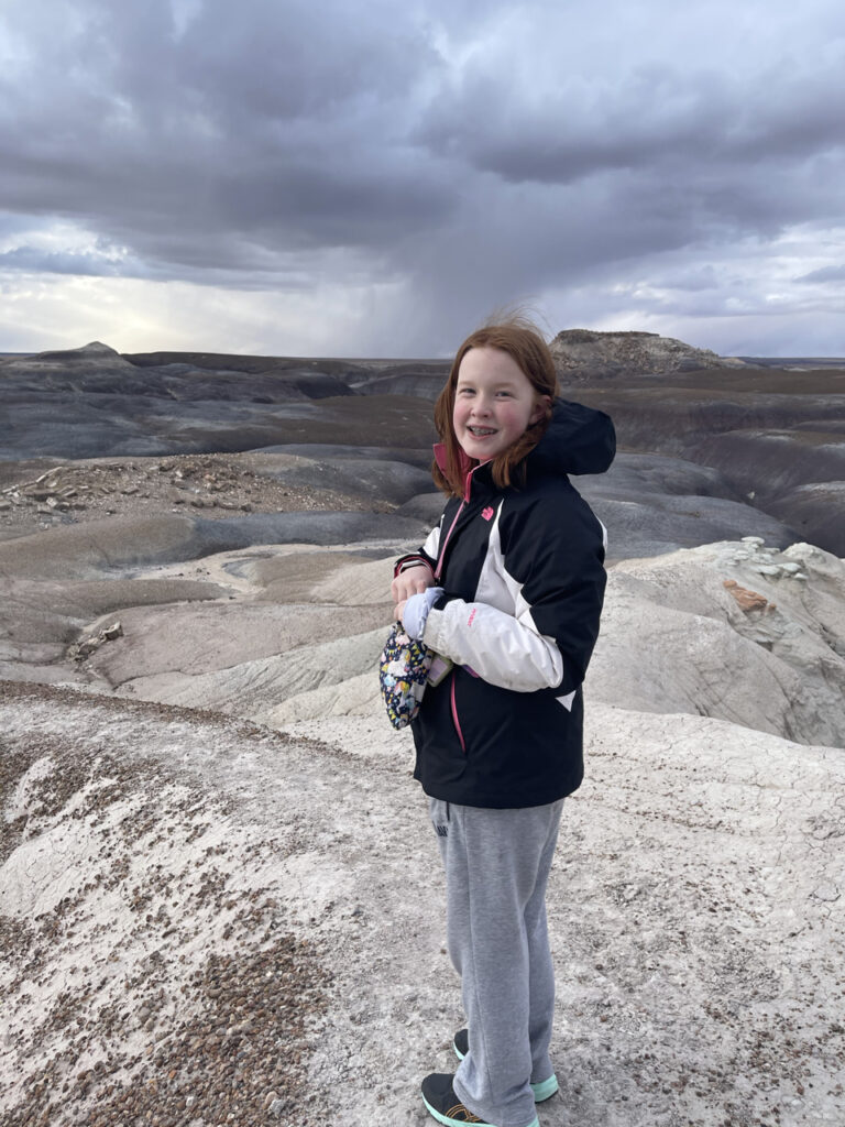 Cameron had hike to the top of one of the badlands on the Blue Forest trail with looming storm clouds in the Petrified Forest National Park.