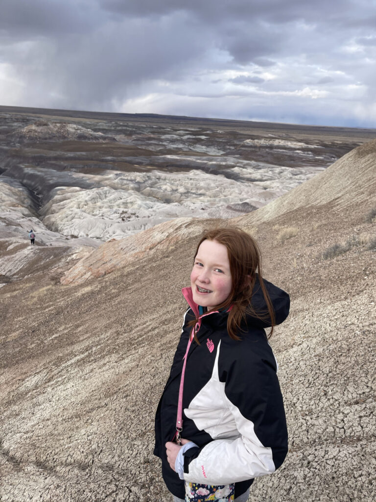 Cameron had hike to the top of one of the badlands on the Blue Forest trail with looming storm clouds in the Petrified Forest National Park.