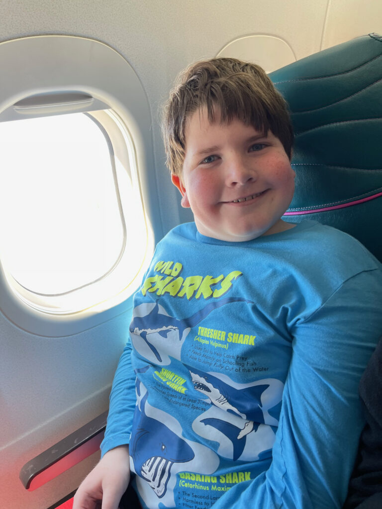 Collin all smiles as he has the window seat on our flight between islands in Hawaii.