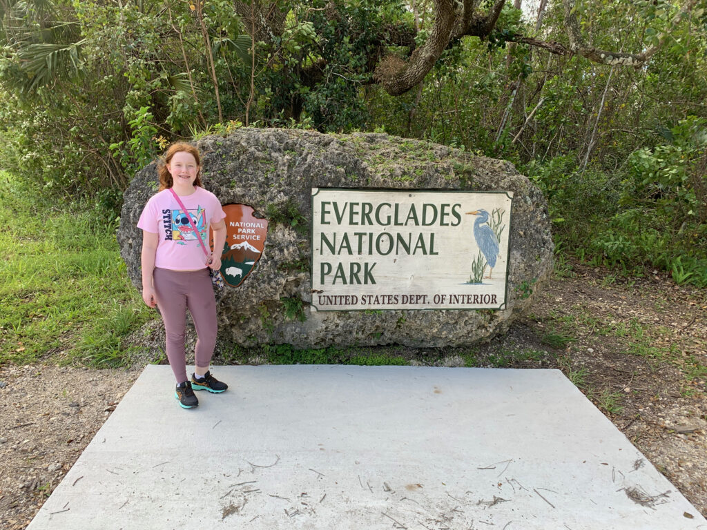 Cami in front of the Everglades National Park sign in Florida. 