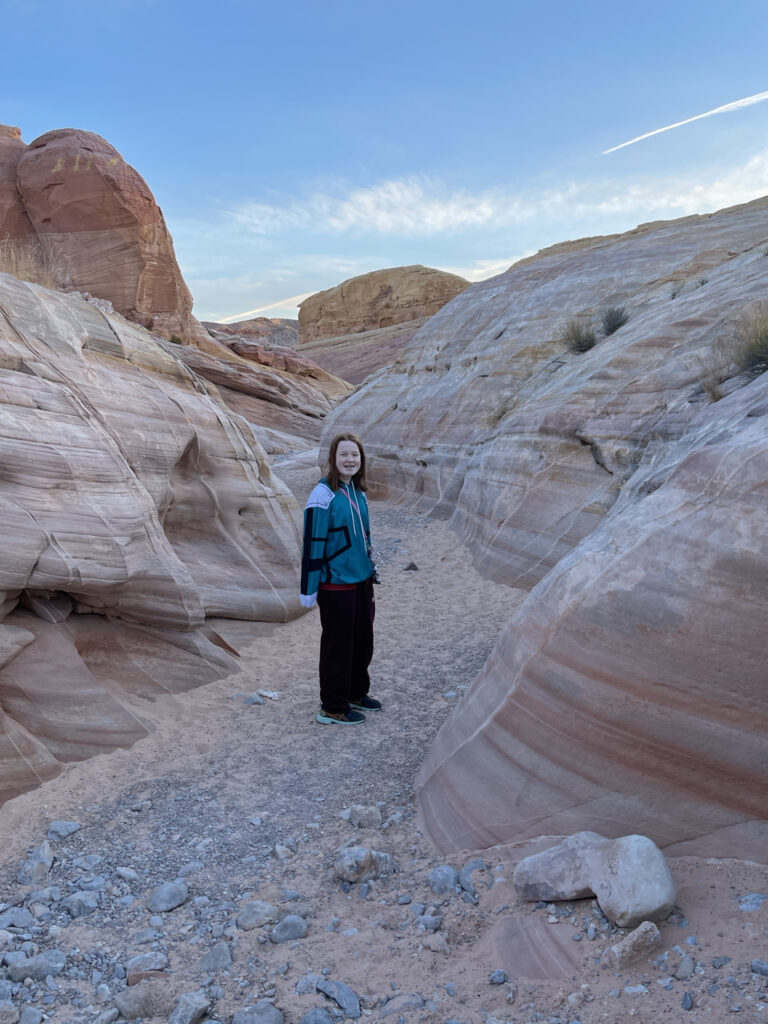 Cameron hiking in the early morning before the sun has touched the ground in the Pastel Canyon Trail in the Valley of Fire State Park.