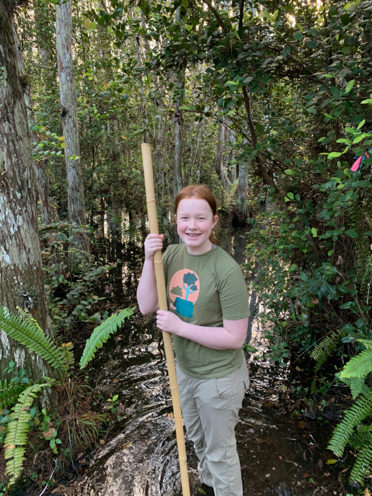 Cameron with a large walking stick about to walk into the Everglades at Big Cypress. 