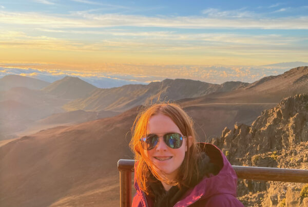 Cameron at sunrise in Haleakala National Park, looking over the crater rim and the clouds that are below us in the distance.