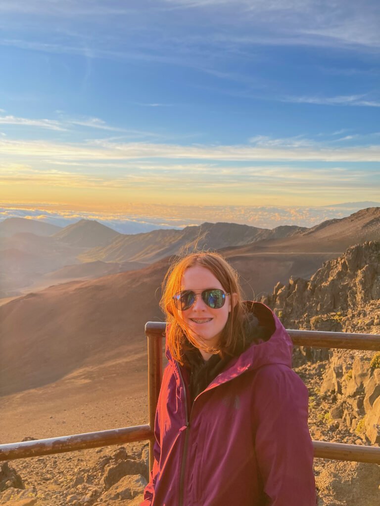 Cameron at sunrise in Haleakala National Park, looking over the crater rim and the clouds that are below us in the distance.