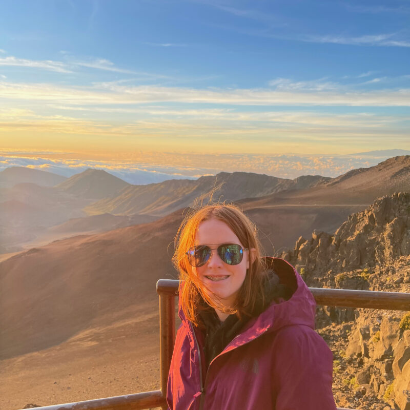 Cameron at sunrise in Haleakala National Park, looking over the crater rim and the clouds that are below us in the distance.