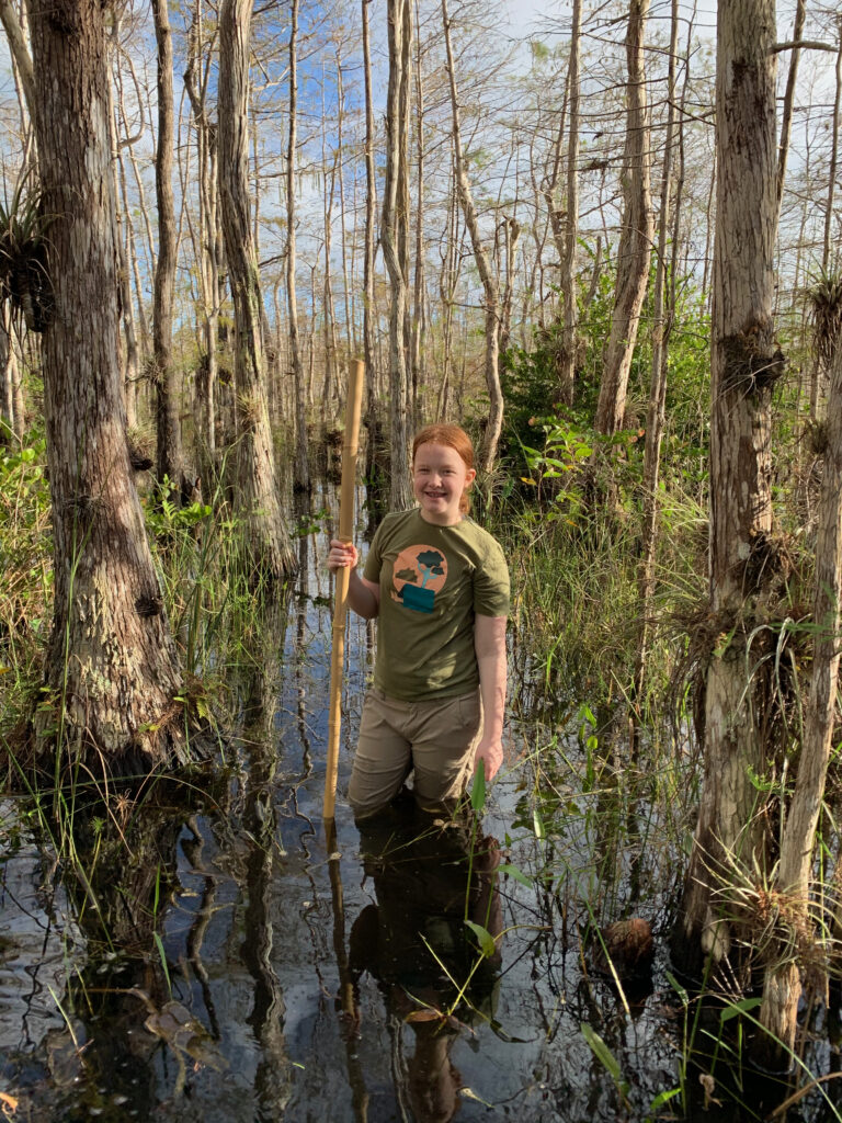 Cameron hiking in the deep water of the Everglades at Big Cypress. 