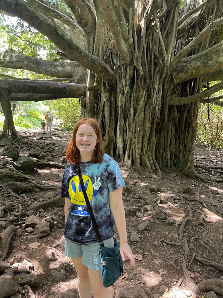 Cameron in front of a giant tree while hiking the Pipiwai Trail.