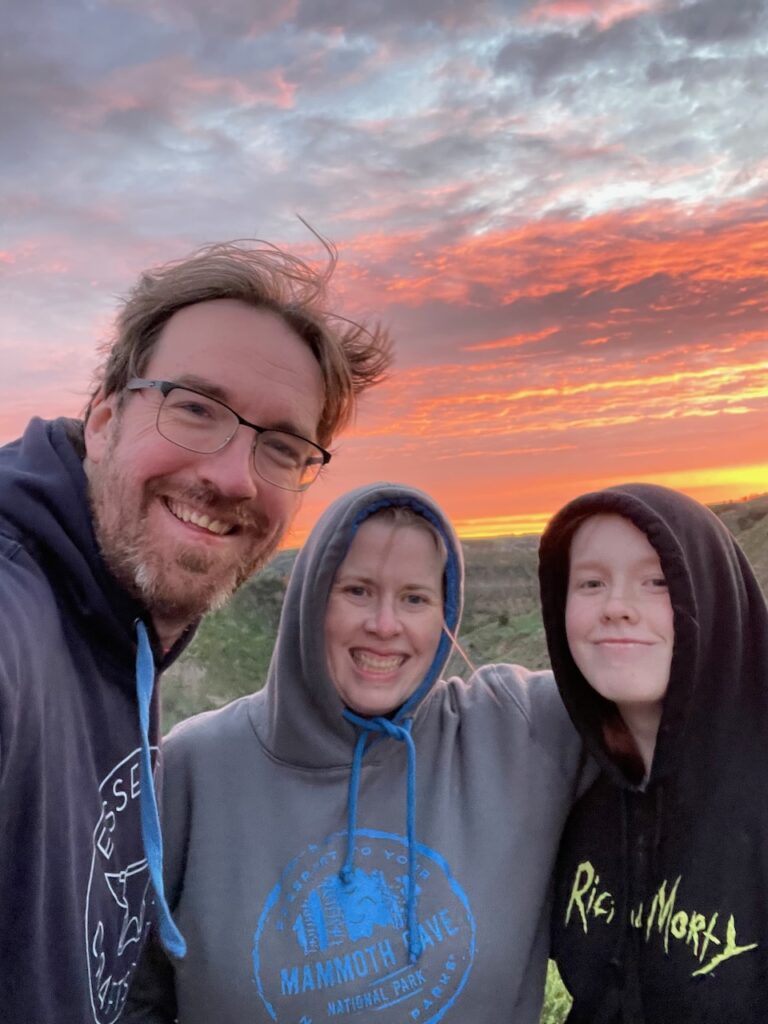 Cat, Cami and myself posing in front of a fiery red sunset in Theodore Roosevelt National Park.