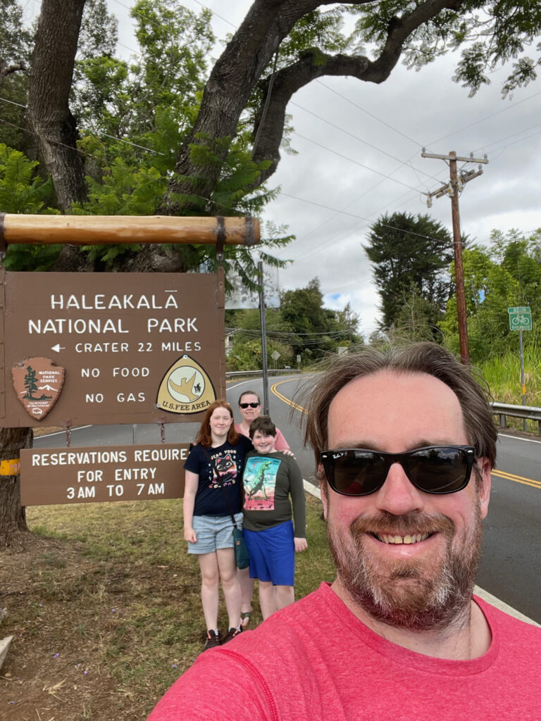 The family, Cat, Cameron, Collin and myself standing in front of teh Haleakala National Park sign at the bottom of the Volcano. 