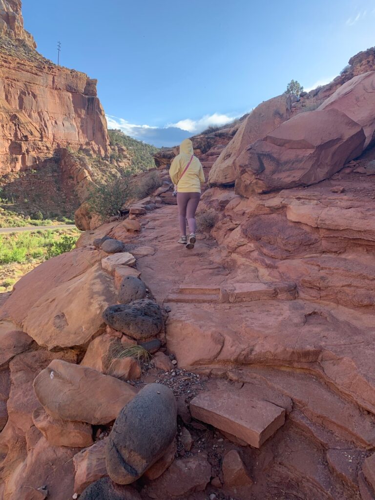 Cameron hiking up to the Hickman Natural Bridge on a stunning summers day in Capitol Reef National Park.