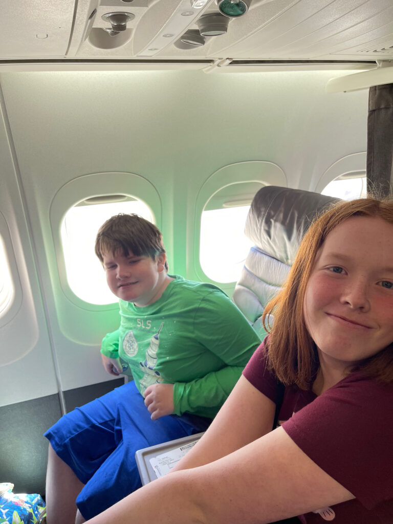 Cameron and Collin all smiles as they sit in first class on a inter-island flight in Hawaii.