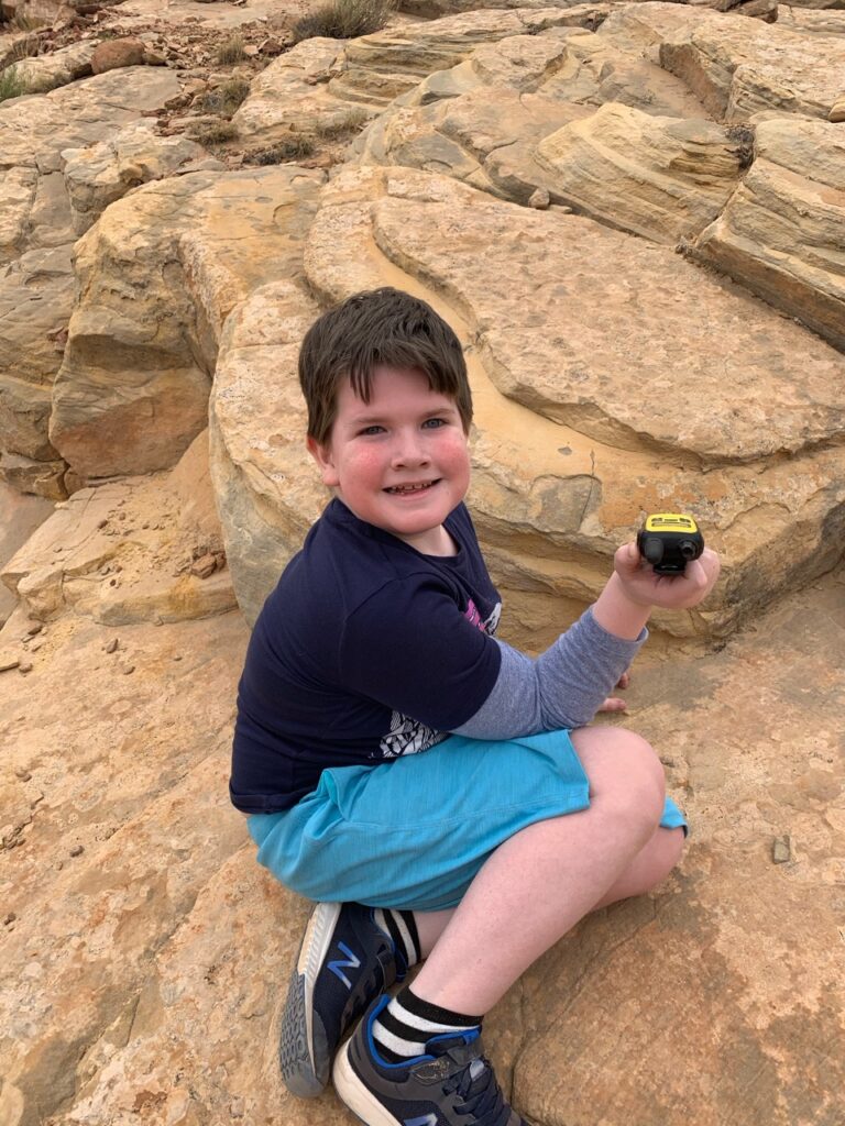 Collin with a radio taking a break on the rocks off the Capitol Gorge Trail in Capitol Reef National Park.