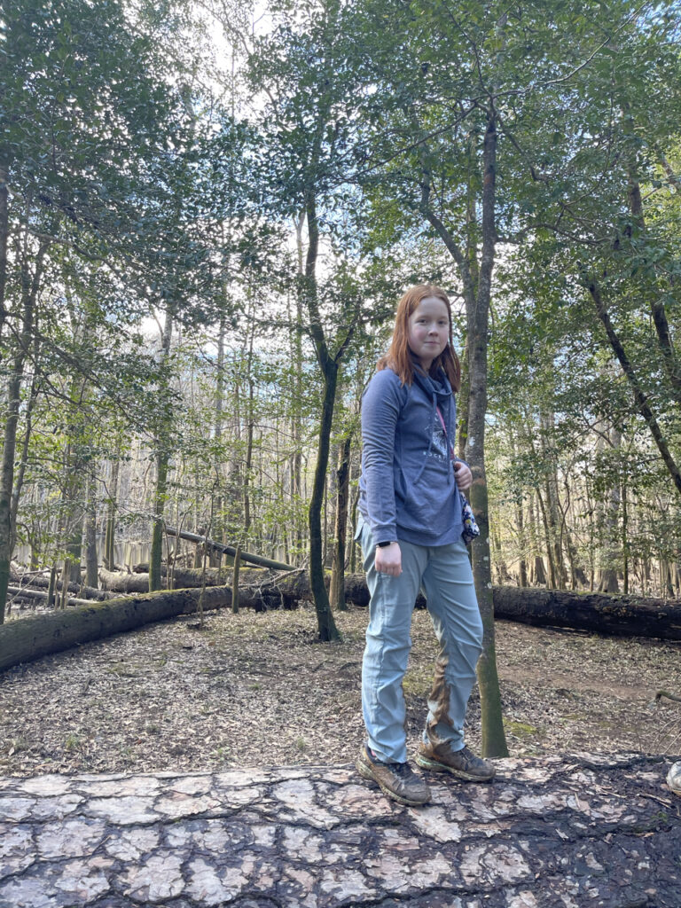 Cameron standing on a fallen Cypress Tree on the banks of the Congaree River deep inside the National Park.