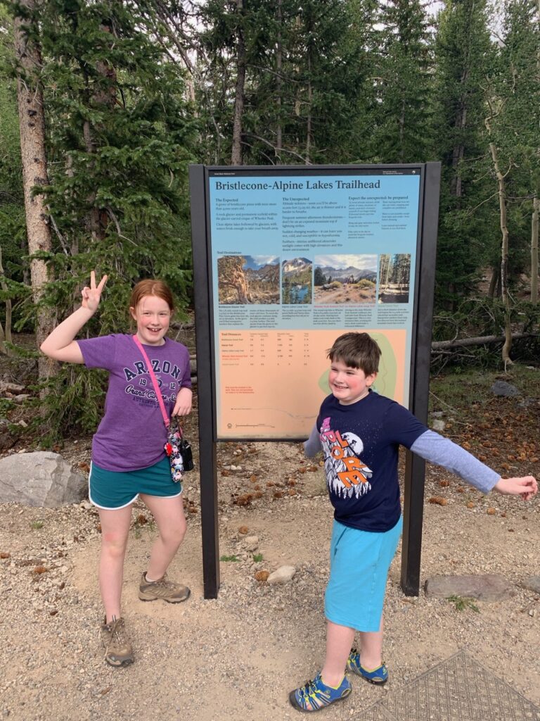 Both Collin and Cameron at the trail head in front of the sign for teh Bristlecone and Alpine lakes trailhead.