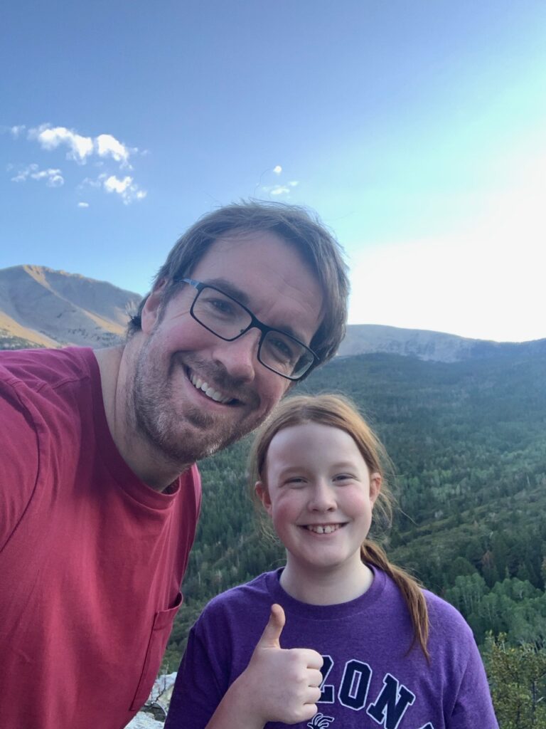 Cameron and myself in the early morning at an overlook in Great Basin National Park with the forest covered valley below us.