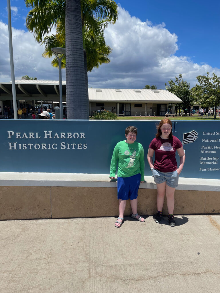 Collin and Cameron in front of the Pearl Harbor sign in Hawaii. 