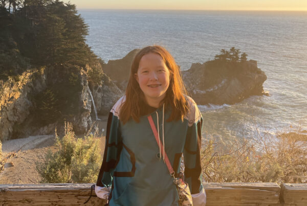 Cameron on the trail above McWay Falls at sunset over the pacific ocean.