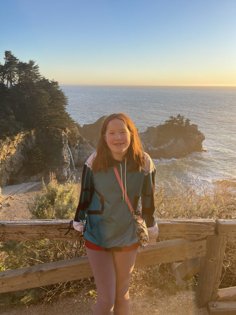 Cameron on the trail above McWay Falls at sunset over the pacific ocean. 