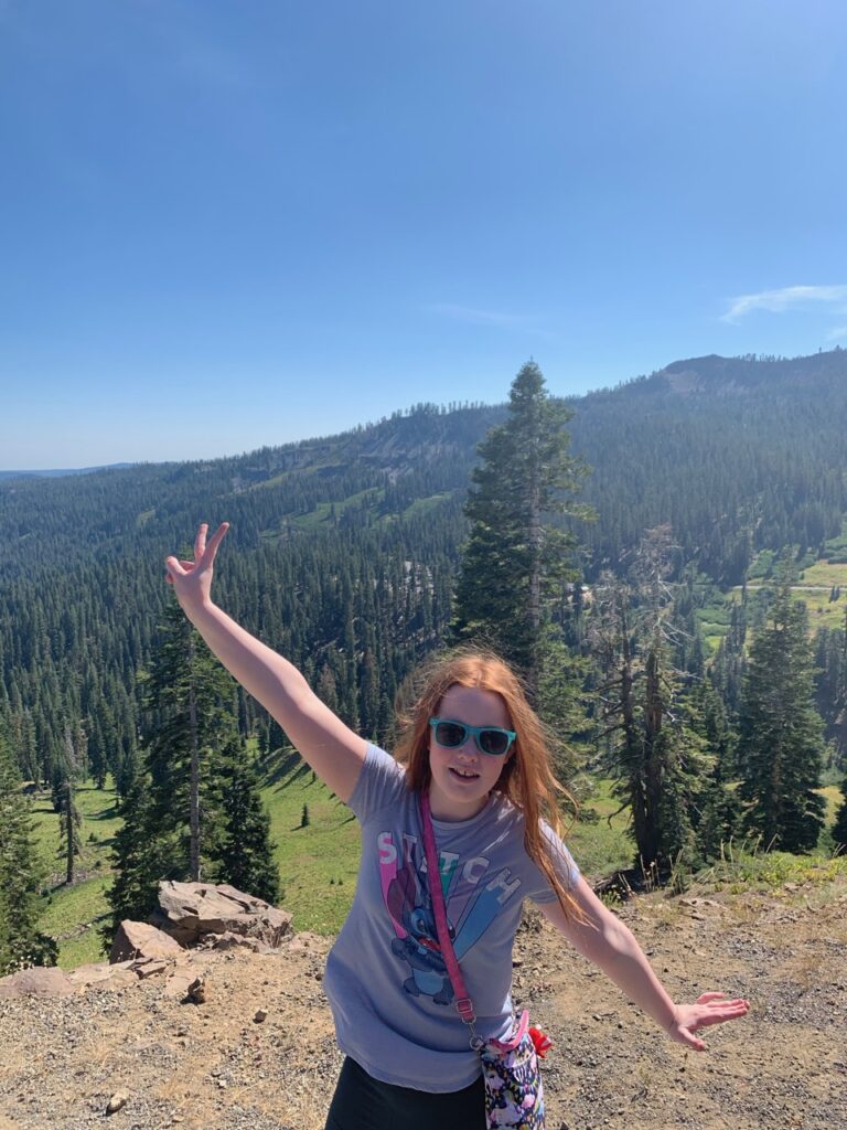 Cameron at an overlook in Lassen Volcanic National Park on a bright sunny day overlooking the valley.