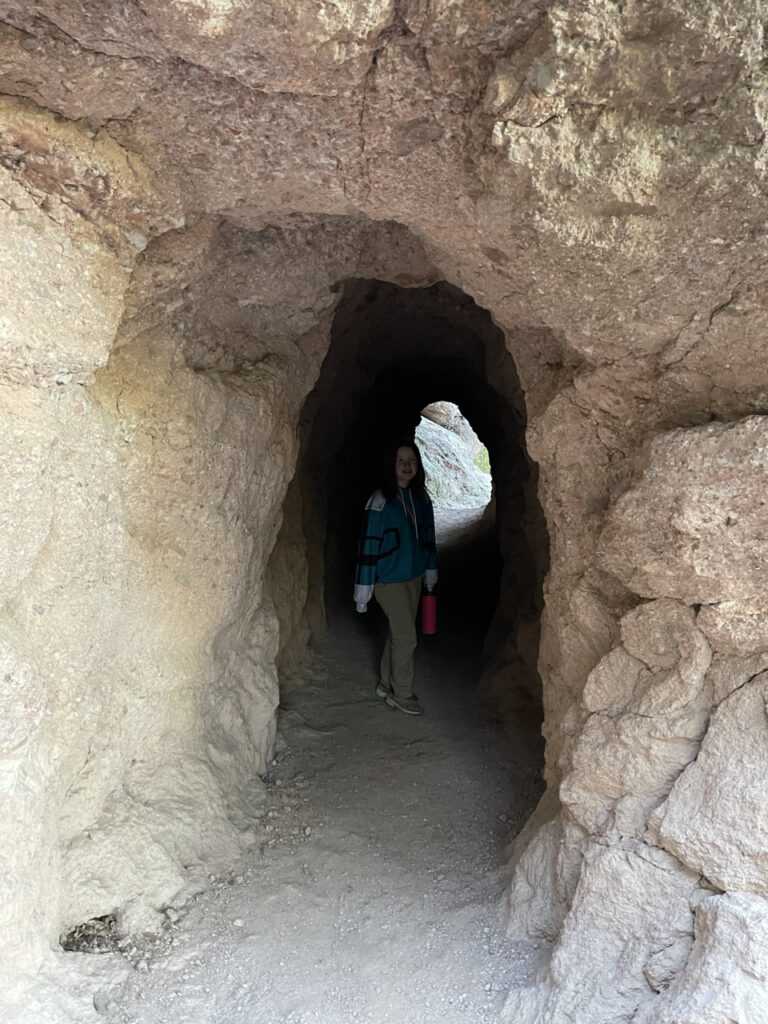 Cameron hiking through a small tunnel on the way to the top of the mountain in Pinnacles National Park. 