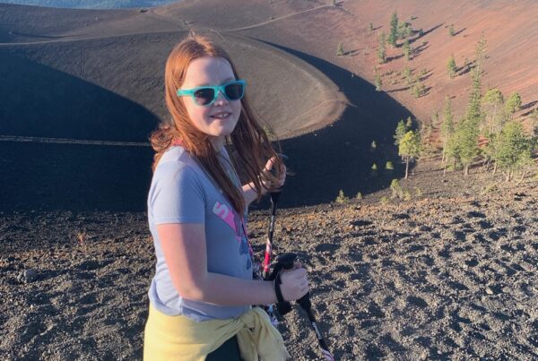 Cameron hiking up the Cinder Cone Volcano in Lassen National Park using hiking poles.