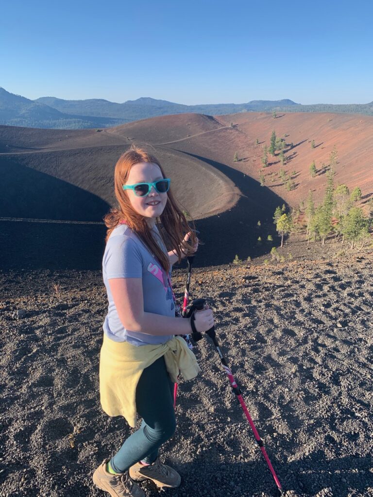 Cameron hiking up the Cinder Cone Volcano in Lassen National Park using hiking poles. 