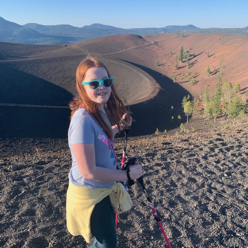 Cameron hiking up the Cinder Cone Volcano in Lassen National Park using hiking poles.