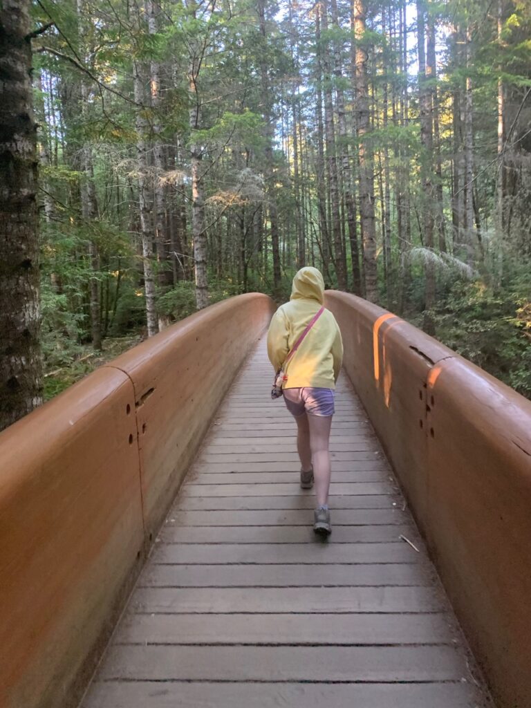 Cameron walking on the bridge over Redwood Creek on the way to the Tall Tress Grove in Redwoods National Park.