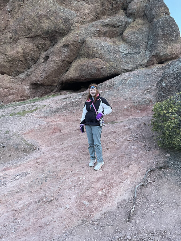 Cameron on steep red rocks on the Rim trail, making our way back to the car. Still wearing, a hat, jacket, and headlamp for our dawn hike.