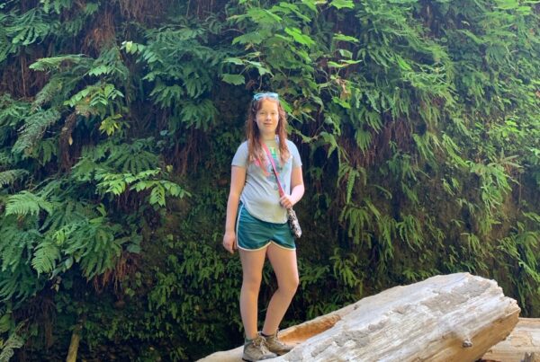 Cameron standing on a fallen log in Fern Canyon in Redwoods National Park.