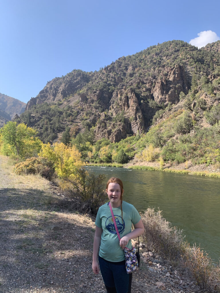 Cameron down by the river off E Portal Rd in the Black Canyon of the Gunnison. Fall colors dot the few tress in the background. 