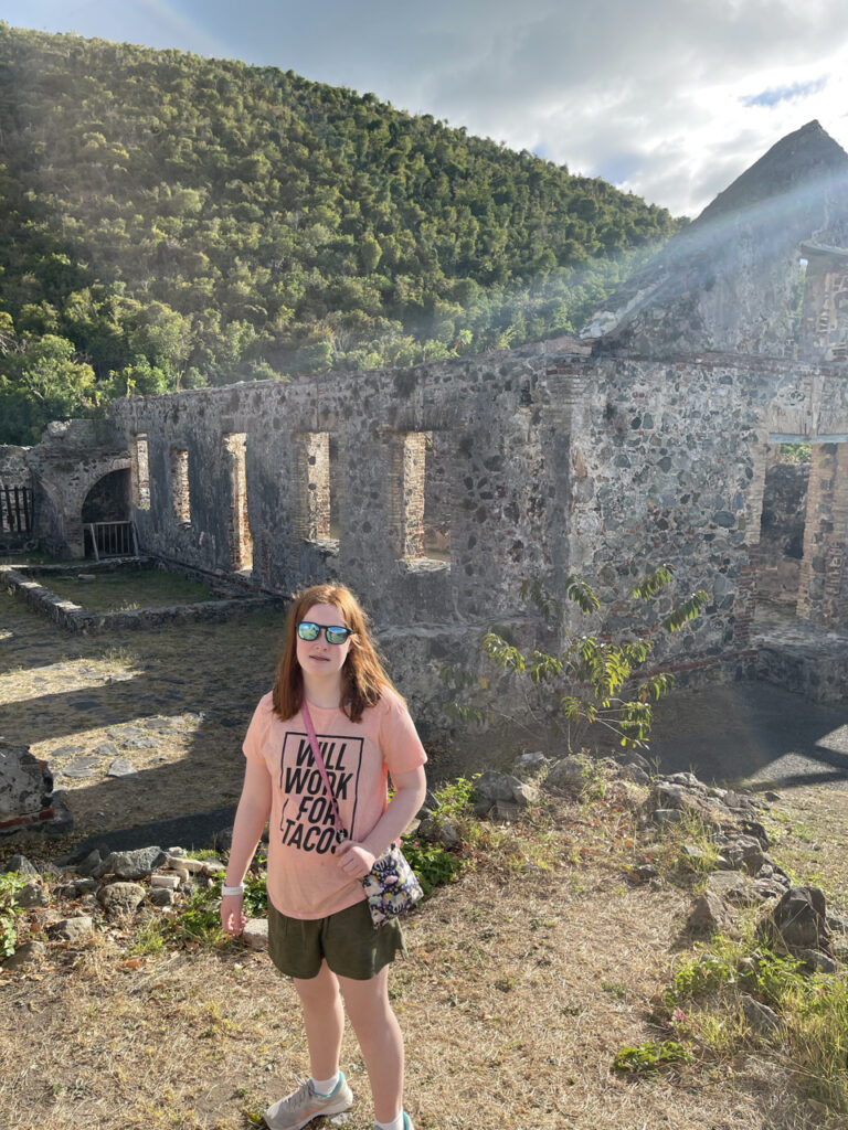 Cameron standing in the ruins of the Annaberg Sugar Plantation. Wearing sunglasses in the bright mid day sunlgiht. 